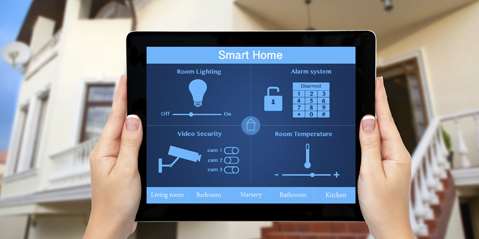 Female hands hold a tablet with system smart house