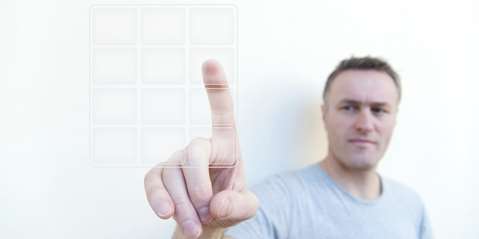 man pressing digital keypad
