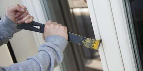 Thief breaking into back door