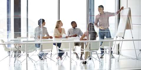 A group of businesspeople sitting in a board meeting