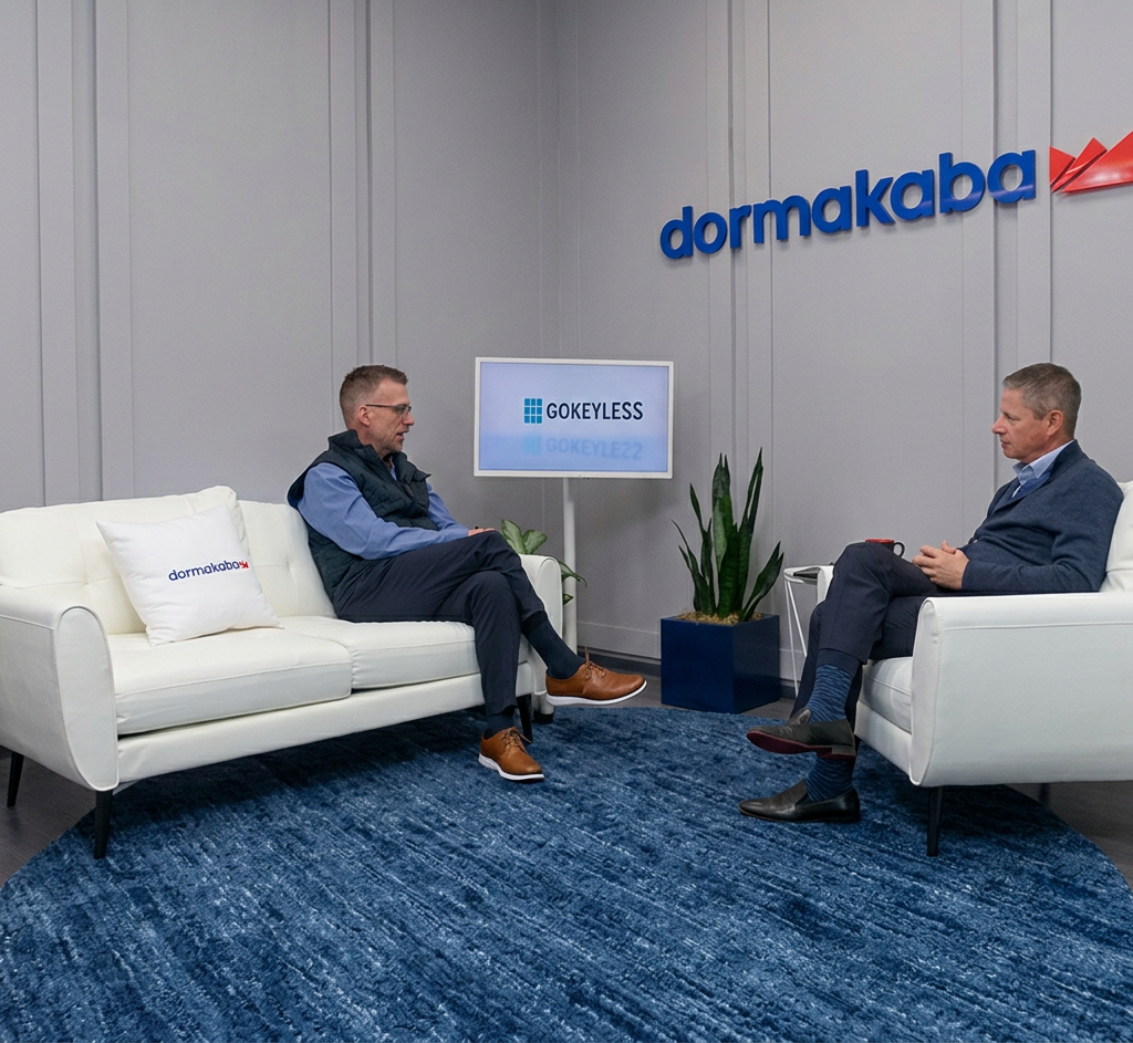 Mike Pennacchio of GoKeyless and Darren Weinstein of dormakaba seated in armchairs having a conversation, with a GoKeyless monitor and dormakaba logo in the background.
