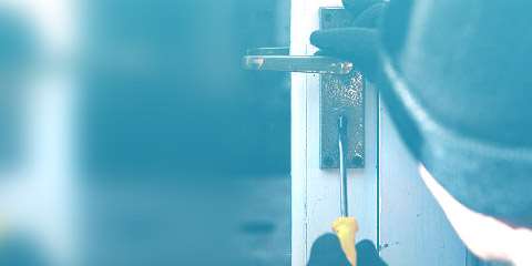 Burglar breaking into lock