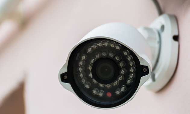 A video surveillance camera set up outside of a home.