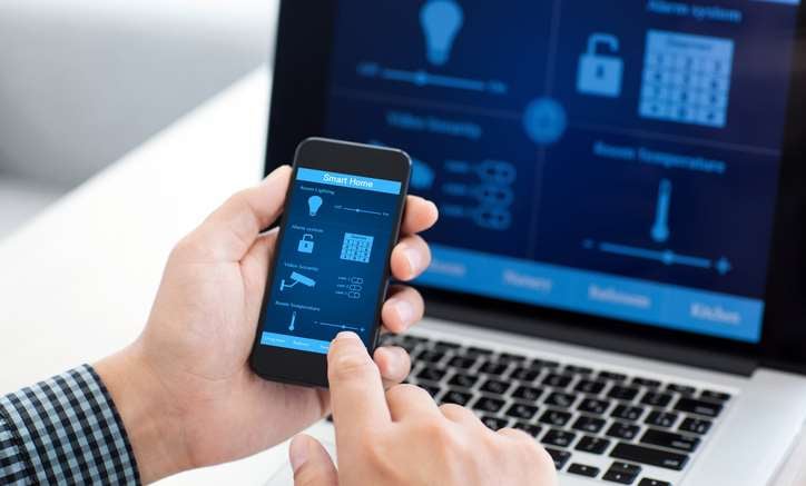 A man uploading his existing home automation information to his new phone.