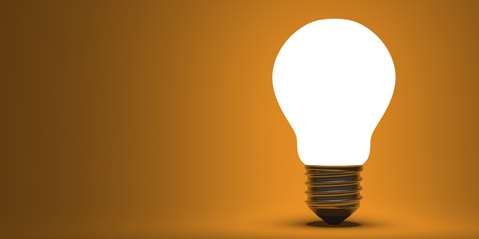 Shining arbitrary light bulb on orange