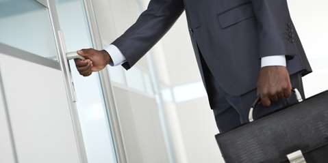 Businessman opening door