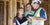 Home builder talking with couple at construction site